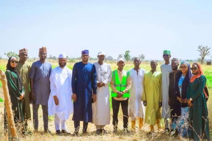 Group photograph during the farm visit documented in the corporate profile
