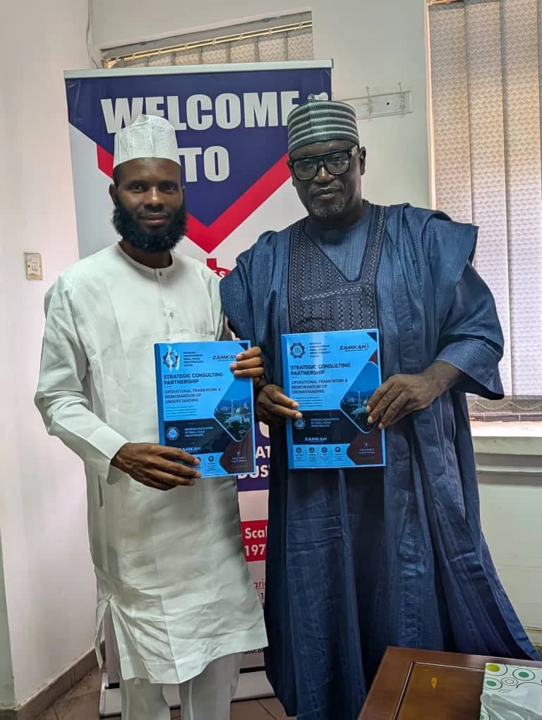 Representatives holding the NASSI and Zamkah strategic consulting partnership document.