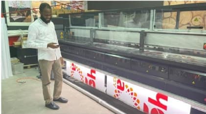 Large-format printing equipment producing Shafa Energy branded graphics.
